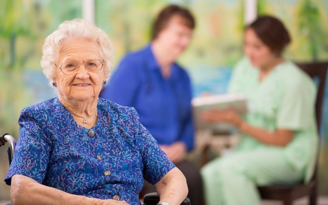 TLC Your Way Home Care Services | York County, Marion County, Florence / Darlington County | smiling elderly woman in chair with caregivers in background
