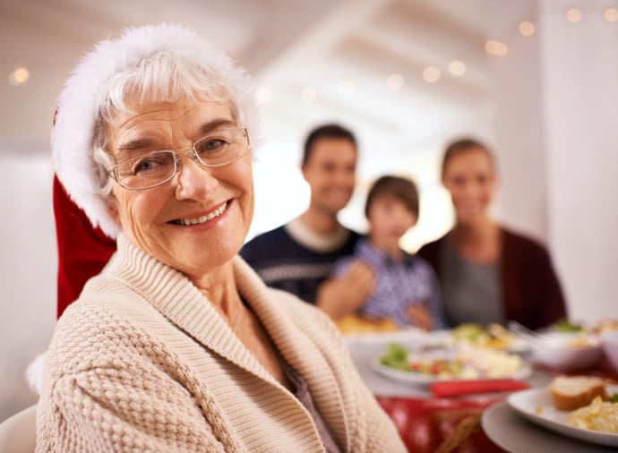 TLC Your Way Home Care Services | York County, Marion County, Florence / Darlington County | happy family sitting around the dinner table at christmas time