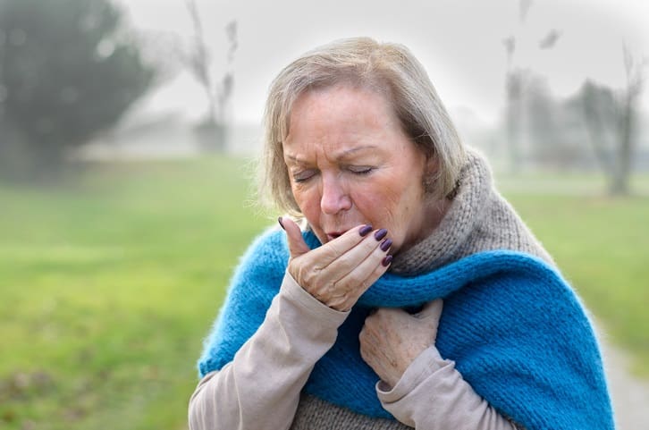 TLC Your Way Home Care Services | York County, Marion County, Florence / Darlington County | elderly woman coughing or sneezing into her hand standing in misty winter field