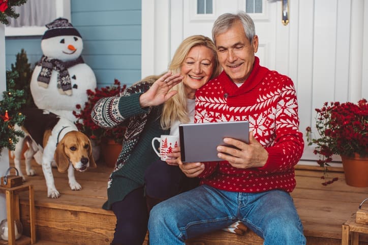 TLC Your Way Home Care Services | York County, Marion County, Florence / Darlington County | mature couple in from of house at christmas time talking on tablet