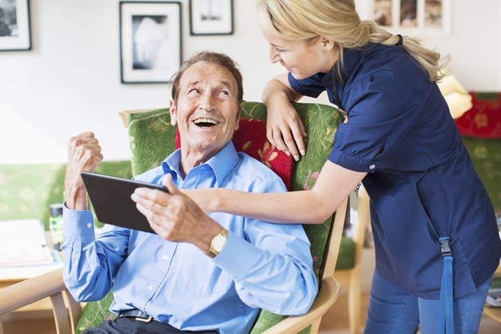 TLC Your Way Home Care Services | York County, Marion County, Florence / Darlington County | happy senior man and female caretaker using digital tablet